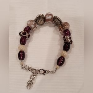 Homemade bracelet with silver lobster claw clasp. Adjustable purple and silver
